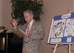 Cranston Williams Jr. speaking beside a display board