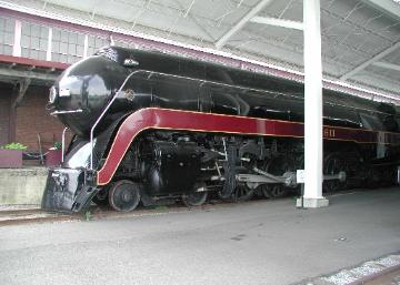 Red and black historic locomotive on display